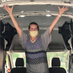 Maggie Lancaster, GRCM CEO, showing off the size of the van inside.